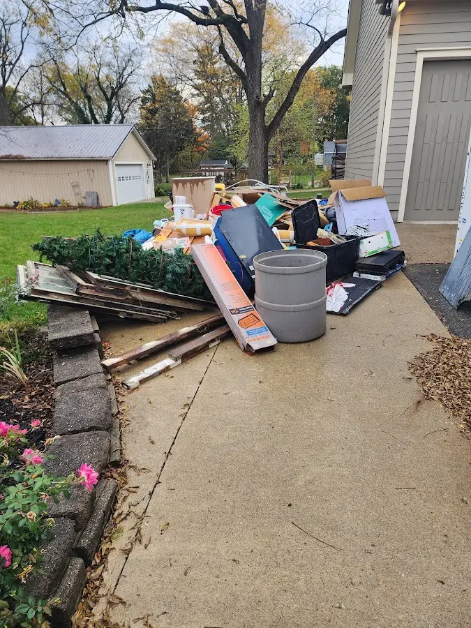 Dumpster being loaded with debris for 12 Yard Dumpster Rental in McComb